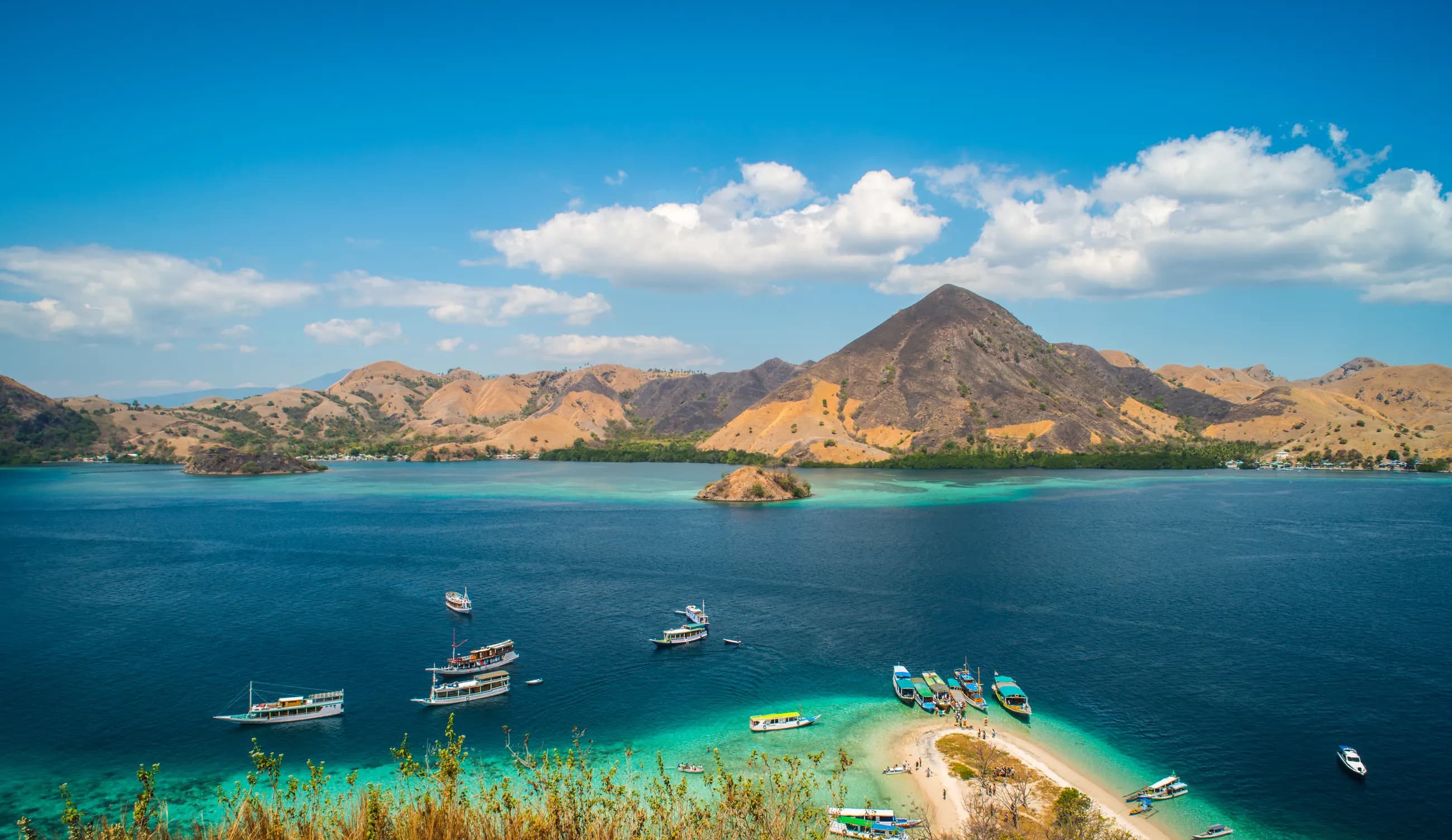 Boats anchored in a turquoise bay near Labuan Bajo, Flores
