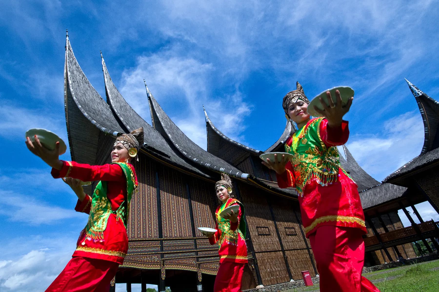Batak dancers in front of a traditional house